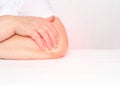 Pain in the elbow joint in a woman, tendonitis and bursitis, degenerative lesions in the joint, white background, copy space,