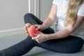 Pain in the foot. Massage of female feet. Ache in the human body on a gray background with red dot. Health care concept Royalty Free Stock Photo