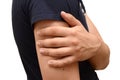 Pain in forearm of a young man, holding his hand to a sore spot. Horizontal photo isolated, medicine concept