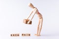 Wood man lifting brown box with red spot and letters back pain