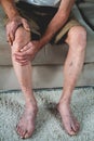 Pain in the legs and knees of an elderly senior Royalty Free Stock Photo