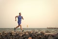 Pain is nothing compared to what it feels like to quit. Running man on beach. Runner training outdoors. Fit male sport