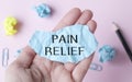 Pain Relief blue paper in hand of Medical Royalty Free Stock Photo