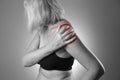 Pain in shoulder, care of female hands, ache in woman`s body Royalty Free Stock Photo