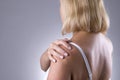 Pain in shoulder, care of female hands, ache in woman`s body Royalty Free Stock Photo