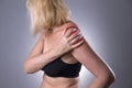 Pain in shoulder, care of female hands, ache in woman`s body Royalty Free Stock Photo