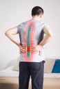 Pain in the spine, a man with backache at home, injury in the lower back Royalty Free Stock Photo