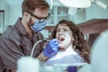 Painful dentist surgery. Woman patient.