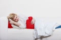 Woman feeling stomach cramps lying on cofa Royalty Free Stock Photo