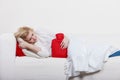 Woman feeling stomach cramps lying on cofa