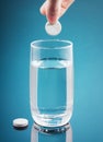 Painkiller tablet in glass of water with bubbles Royalty Free Stock Photo