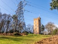 Painshill Park, Cobham Surrey, England. February 11 2020 Gothic tower and electricity pylon