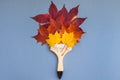 Paint brush with dry bright autumn leaves concept