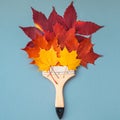 Paint brush with dry bright autumn leaves concept