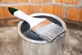 Paint brush in grey color laying on can Royalty Free Stock Photo