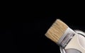 Paint brush and metal can of paint on a black background. Copy space. Close-up Royalty Free Stock Photo