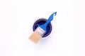 paint brush on an open blue paint can isolated on white background Royalty Free Stock Photo