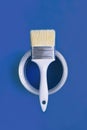 Paint brush with an open can of paint on trendy Classic Blue background. Color of the year 2020. Royalty Free Stock Photo