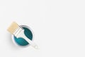 Paint brush with an open can of turquoise paint on white background. Top view, flat lay Royalty Free Stock Photo