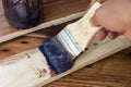 Paint brush with Shellac oil paint on wood Royalty Free Stock Photo