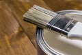 Paint brush on a tin can with white paint close-up Royalty Free Stock Photo