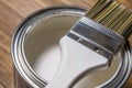 Paint brush on a tin can with white paint close-up Royalty Free Stock Photo