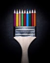 Paint brush with various different colored pencils. Royalty Free Stock Photo