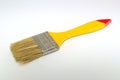 Paint brush width 2 inches with a yellow handle on a white background Royalty Free Stock Photo