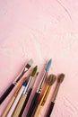 Paint brushes, artist tools for drawing on textured pink background
