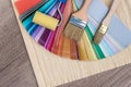 Paint brushes on colour swatch, wooden table background