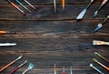 Paint brushes on a dark wooden background, top view. Concept of Royalty Free Stock Photo
