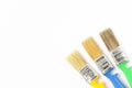 Paint brushes of different colors on a white background close-up, flat lay, place for text Royalty Free Stock Photo