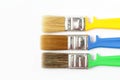 Paint brushes of different colors on a white background close-up, flat lay, place for text Royalty Free Stock Photo