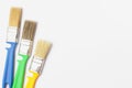 Paint brushes of different colors on a white background close-up, flat lay, place for text Royalty Free Stock Photo