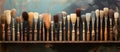 Paint brushes neatly displayed on wood shelf in front of art painting Royalty Free Stock Photo