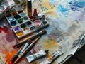 Paint brushes and paints on a table in an artist\'s studio Royalty Free Stock Photo