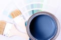 Paint brushes placed on top of can filled with blue paint. Classic blue color of year 2020. Royalty Free Stock Photo