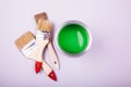 Paint brushes placed on top of can filled with green paint Royalty Free Stock Photo