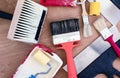 Paint brushes, rollers and putty knifes on a wooden background