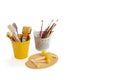 Paint brushes, rollers and spatulas in buckets and round sponge foam brush on a wooden pallette Royalty Free Stock Photo