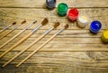 Paint brushes and a white sheet of paper. Composition of watercolor and gouache paints on a wooden background. Royalty Free Stock Photo