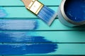 Paint can, brush and stroke on blue wooden background Royalty Free Stock Photo