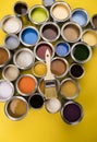 Paint can with a paintbrush, yellow background