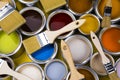 Paint can with a paintbrush, yellow background