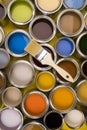 Paint can with a paintbrush, yellow background