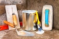 Paint can and tools on a concrete wall Royalty Free Stock Photo