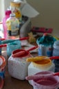 Paint cans and brushes on different colors