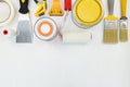 paint cans, brushes, putty knife and rollers on white wooden background Royalty Free Stock Photo