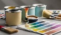 Paint cans, color palette samples and brushes on table Royalty Free Stock Photo