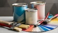 Paint cans, color palette samples and brushes on table Royalty Free Stock Photo